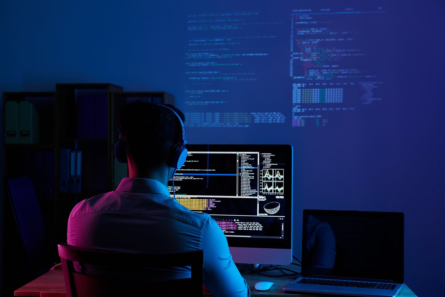 A developer working at a desk with monitors